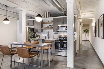 A kitchen and dining area in a loft